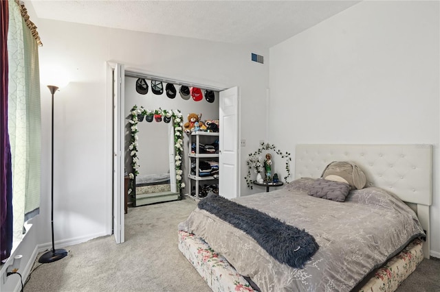 bedroom with light carpet, a textured ceiling, and lofted ceiling