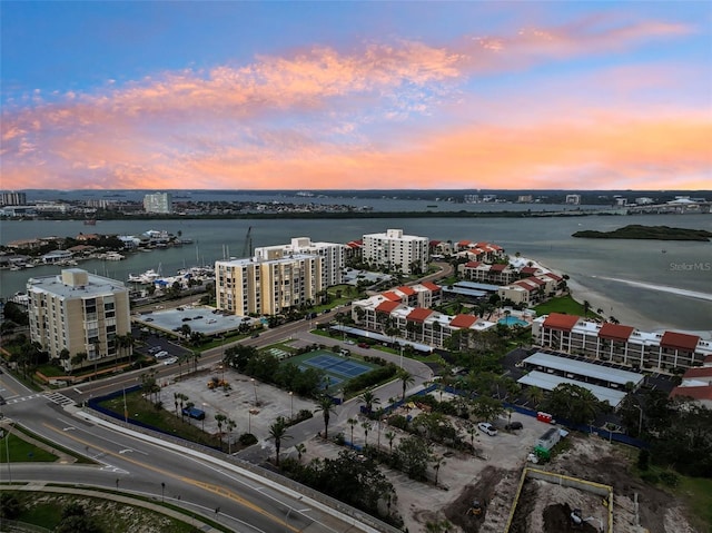 aerial view at dusk with a view of city and a water view