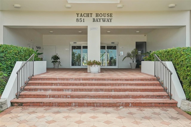 entrance to property featuring stucco siding