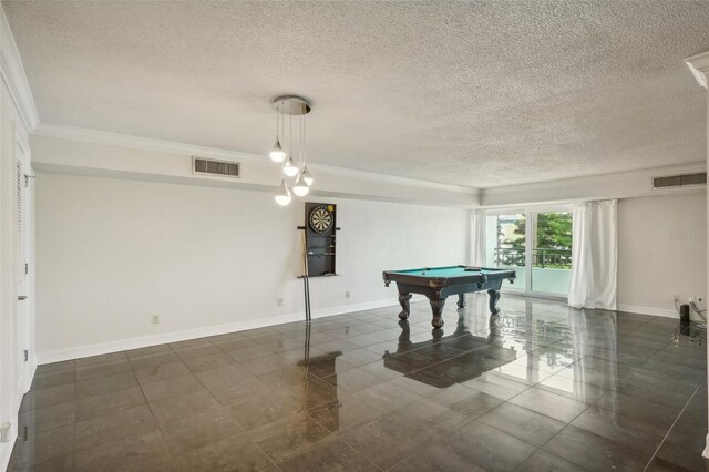 rec room with ornamental molding, a textured ceiling, dark tile patterned flooring, and billiards