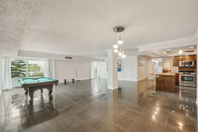 rec room featuring visible vents, a raised ceiling, a textured ceiling, and baseboards