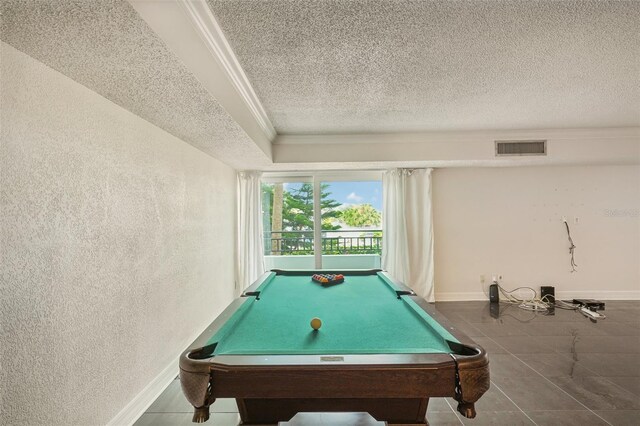 rec room featuring tile patterned floors, a raised ceiling, pool table, and a textured ceiling