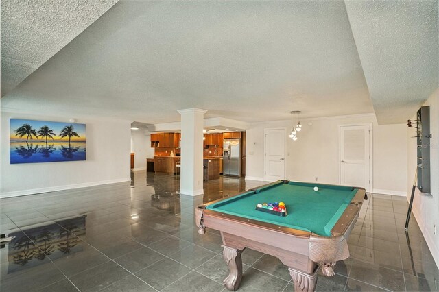 rec room featuring tile patterned flooring, pool table, a textured ceiling, and baseboards