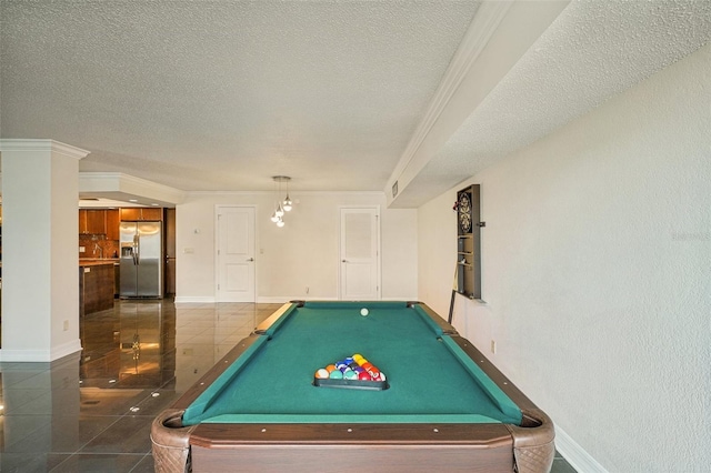 game room with baseboards, a textured ceiling, ornamental molding, and tile patterned flooring