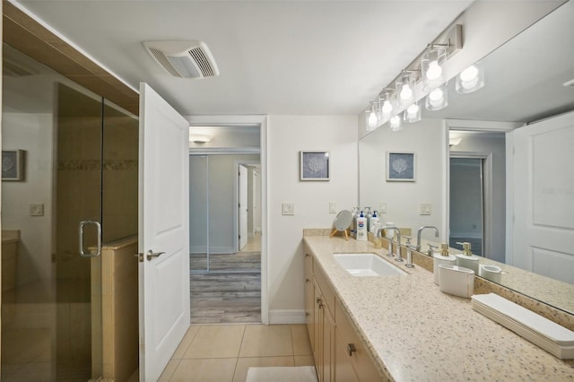 full bath with visible vents, a shower stall, baseboards, tile patterned floors, and vanity