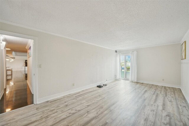 unfurnished room with ornamental molding, light hardwood / wood-style flooring, and a textured ceiling