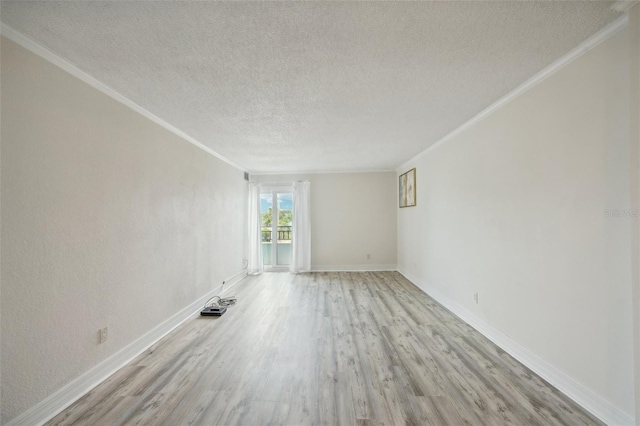 unfurnished room featuring a textured ceiling, light wood-style flooring, baseboards, and ornamental molding