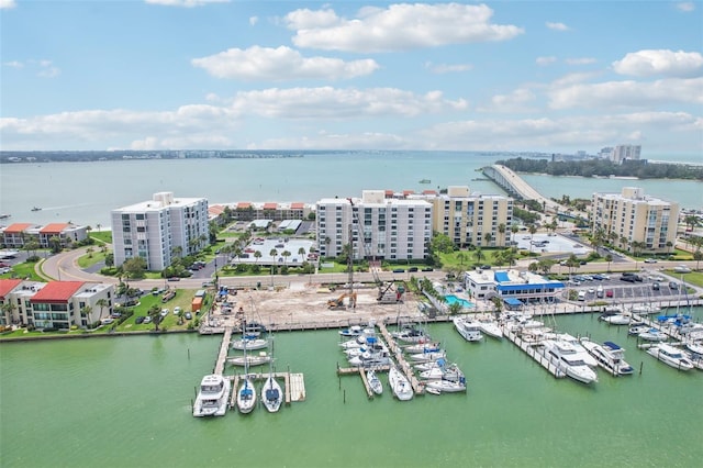 drone / aerial view with a city view and a water view