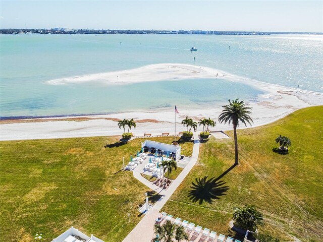 drone / aerial view featuring a water view and a beach view