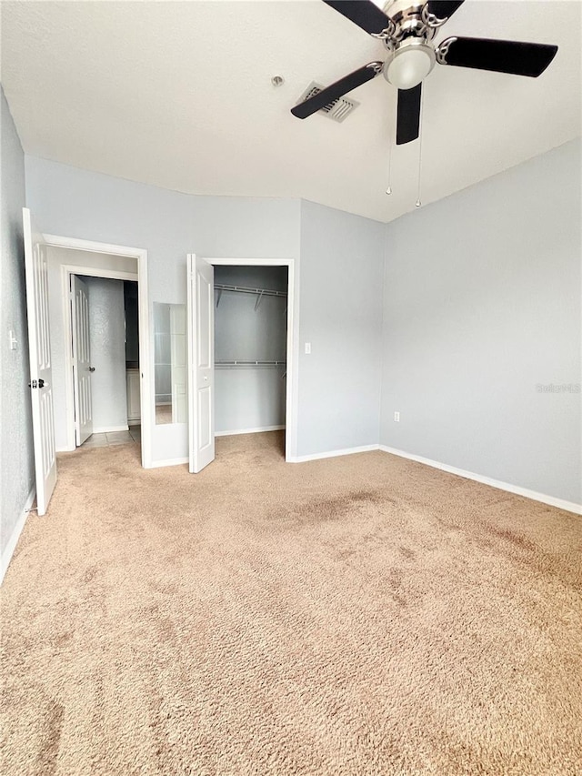 unfurnished bedroom with ceiling fan and light carpet