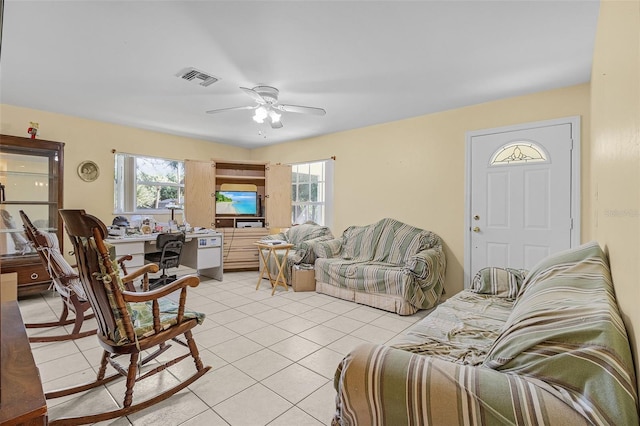 tiled living room with ceiling fan