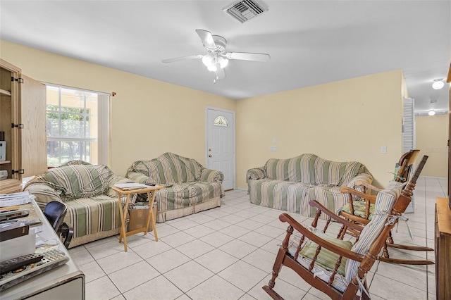 living room with ceiling fan and light tile patterned flooring