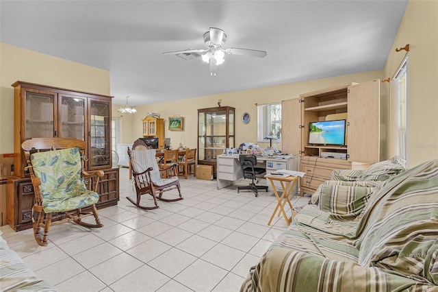 living room with light tile patterned floors and ceiling fan with notable chandelier