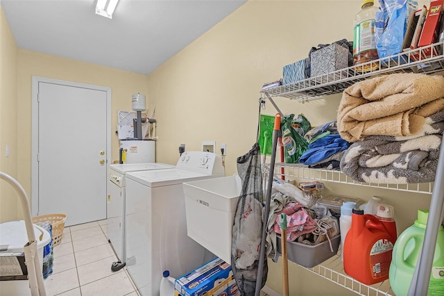 laundry area featuring gas water heater, separate washer and dryer, and light tile patterned flooring