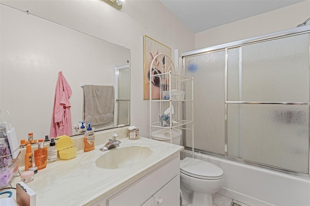 full bathroom with vanity, toilet, bath / shower combo with glass door, and tile patterned floors