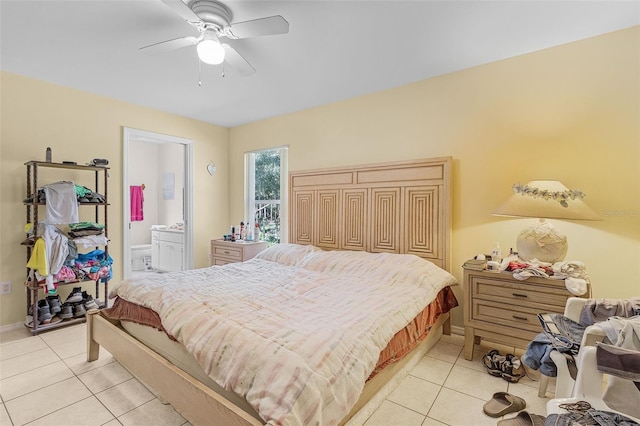 bedroom featuring ceiling fan, ensuite bathroom, and light tile patterned flooring