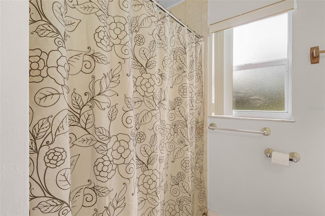 bathroom featuring a shower with curtain