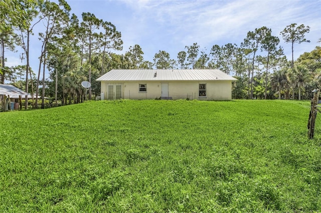 rear view of property with a yard