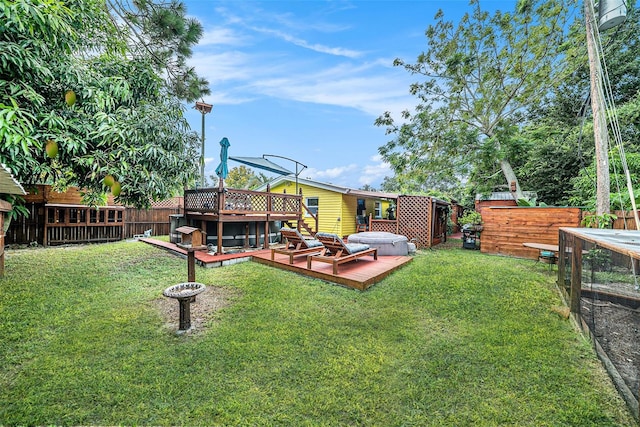 view of yard with a hot tub and a deck