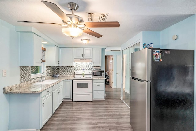 kitchen featuring sink, backsplash, white cabinets, and stainless steel appliances