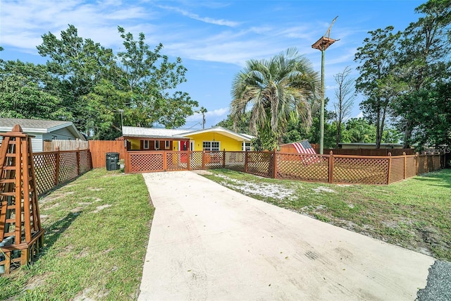 view of yard featuring driveway and a fenced backyard