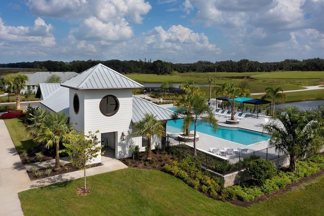 view of swimming pool with a yard and a patio