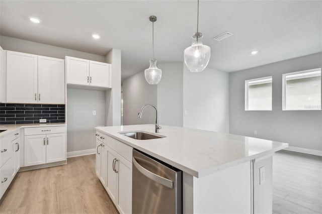 kitchen featuring sink, white cabinetry, hanging light fixtures, dishwasher, and a kitchen island with sink