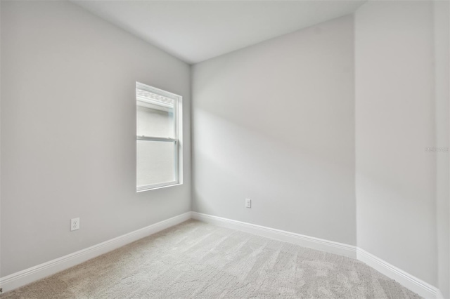 unfurnished room featuring light colored carpet