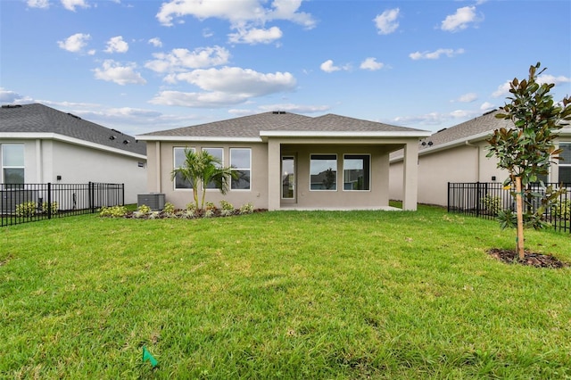 back of property featuring a yard