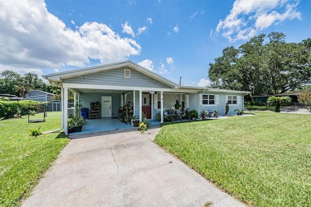 view of front of home with a front yard and a carport