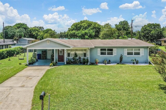 single story home with a front lawn and a carport