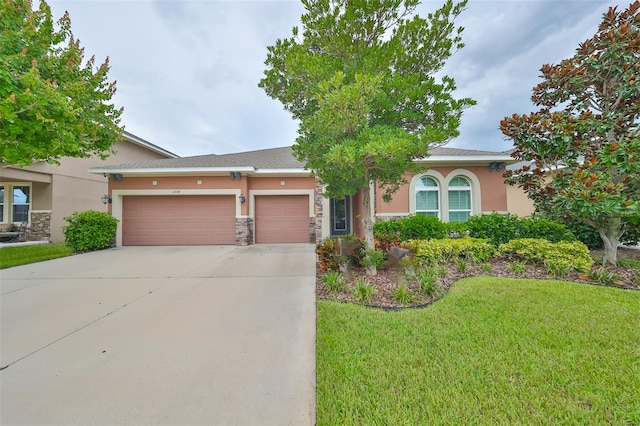 view of front of house with a garage and a front yard