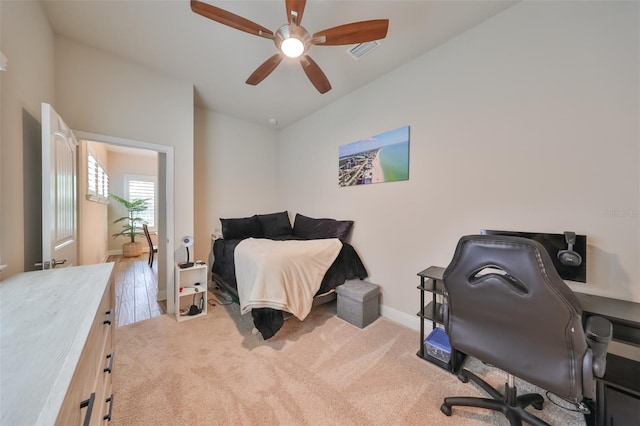 carpeted bedroom with lofted ceiling and ceiling fan