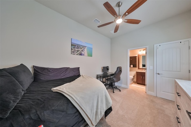 bedroom with ceiling fan, lofted ceiling, connected bathroom, and light carpet