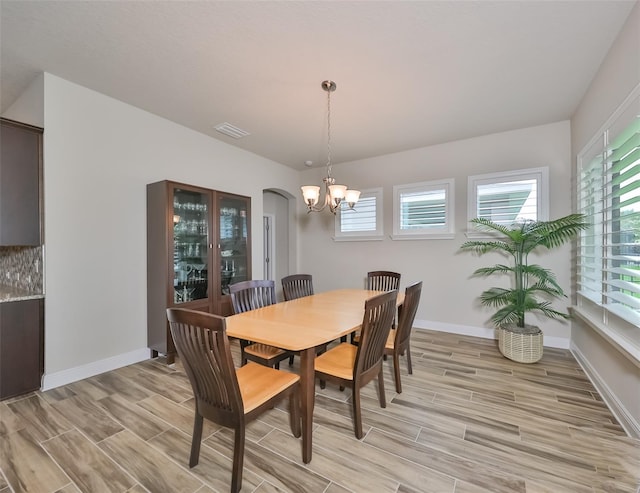 dining space with a chandelier