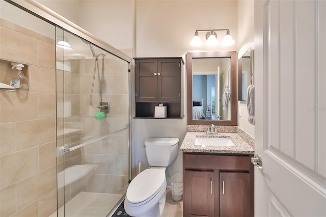 bathroom with toilet, vanity, and walk in shower