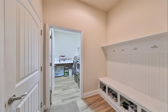 mudroom with washing machine and dryer and light wood-type flooring