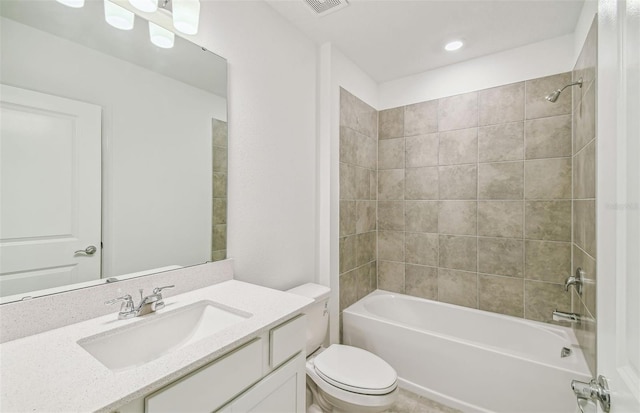 full bathroom featuring vanity, toilet, and tiled shower / bath