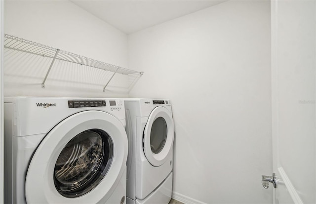 clothes washing area with washing machine and dryer