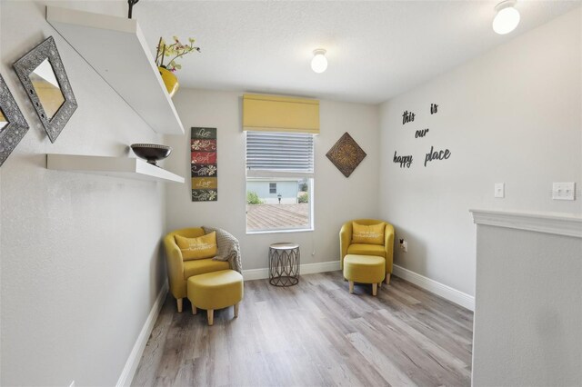 sitting room with light hardwood / wood-style floors