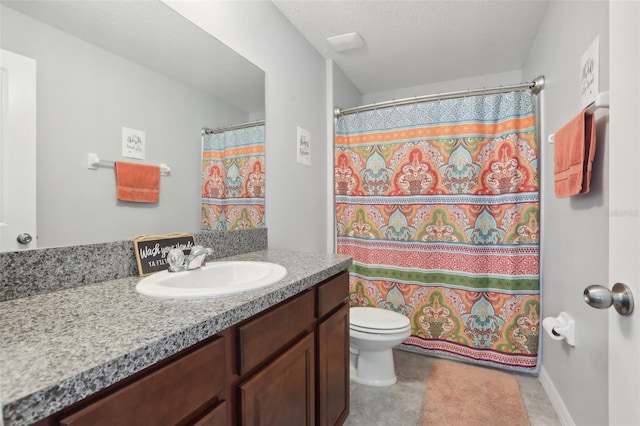 bathroom with a textured ceiling, toilet, vanity, and tile patterned flooring