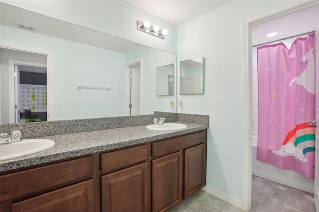 bathroom with shower / tub combo, vanity, and tile patterned floors