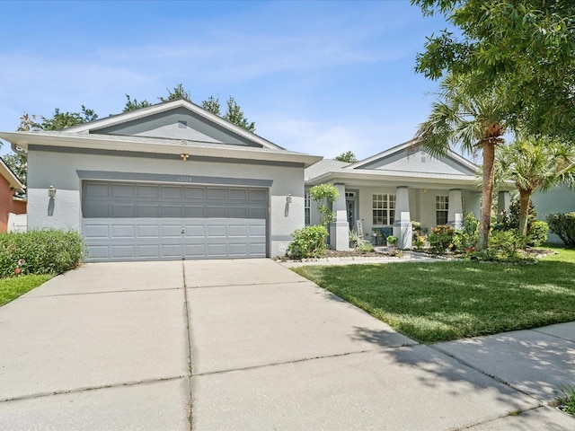 ranch-style house featuring a garage and a front lawn