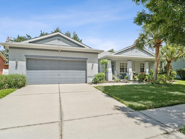 single story home featuring a garage and a front yard