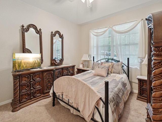 bedroom featuring light colored carpet and ceiling fan