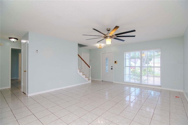 empty room featuring ceiling fan and light tile patterned floors