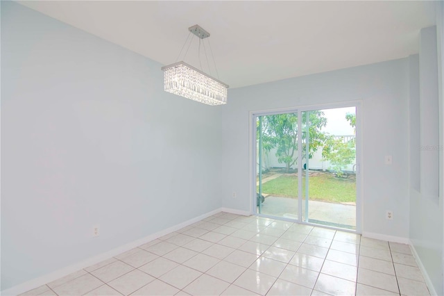 spare room with light tile patterned flooring and an inviting chandelier