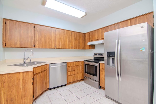 kitchen featuring sink, stainless steel appliances, and light tile patterned flooring