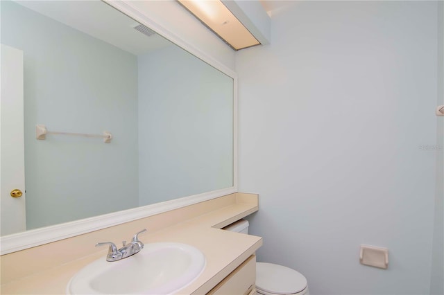 bathroom with toilet and vanity