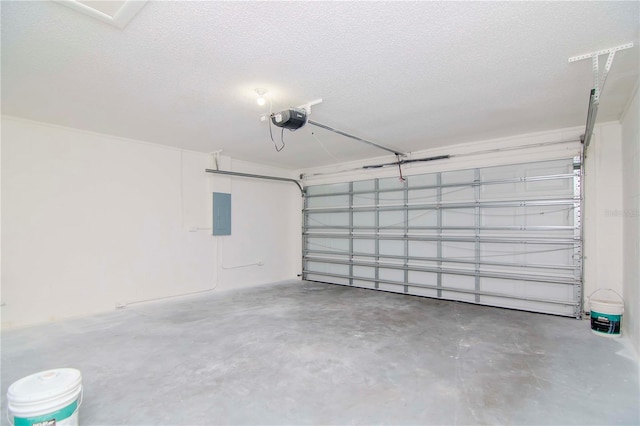 garage with a garage door opener and electric panel